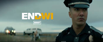 image 1 DUI Police officer in foreground, cars and people in blurred background